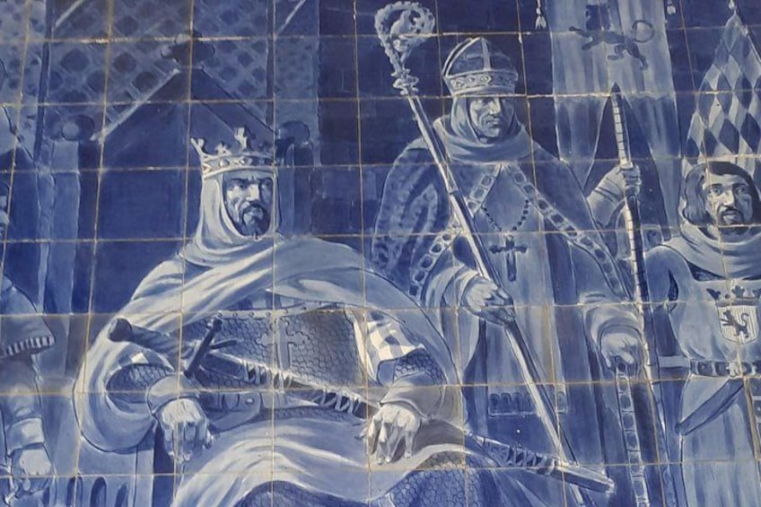 A tiled wall with figures in medieval attire, including crowns and religious symbols. 2