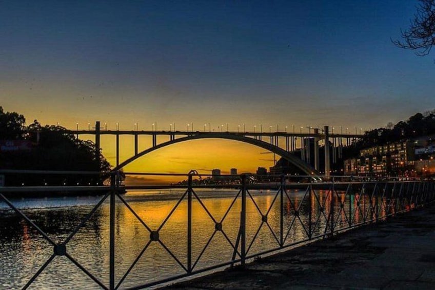 A bridge at sunset with a reflection on the water. 4