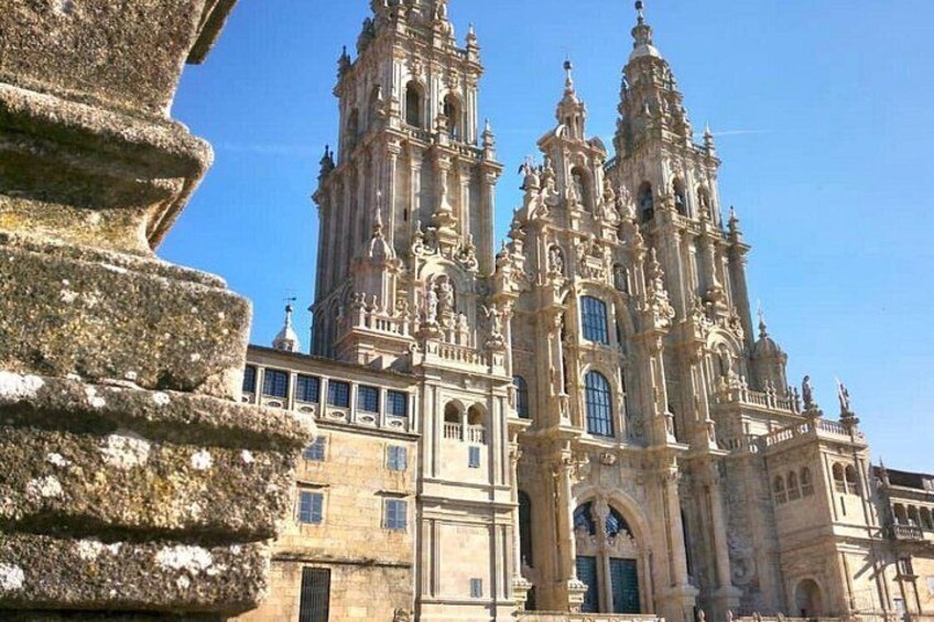 A historic cathedral with intricate architecture, a prominent bell tower, and a stone staircase. 1