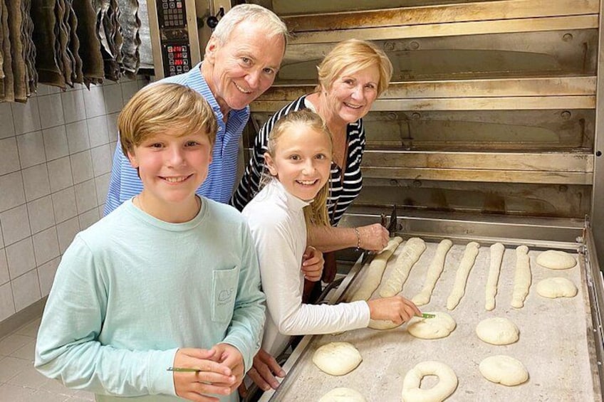A family in a bakery, dough on a baking tray. 2