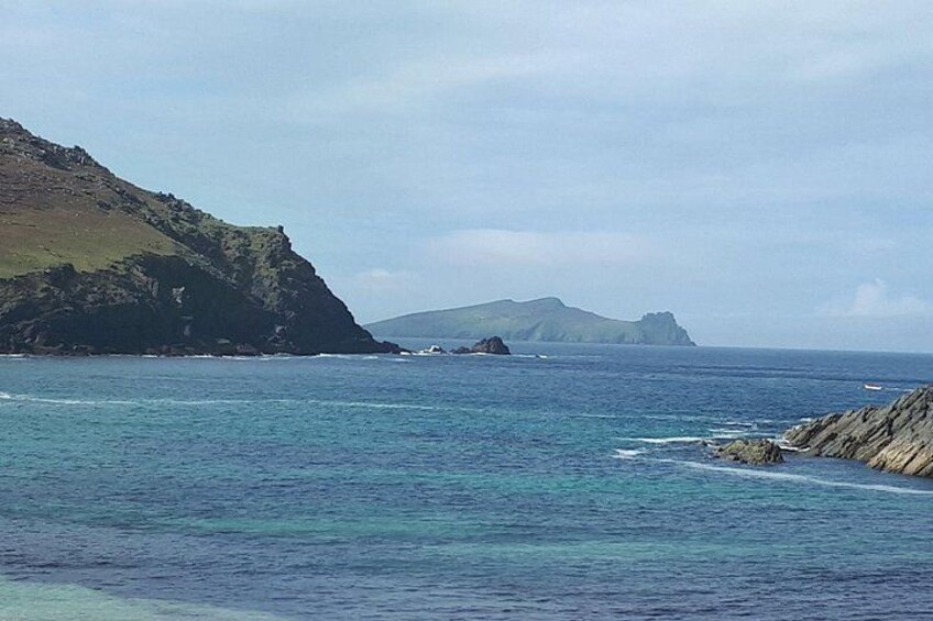 Un paisaje costero con aguas azules cristalinas, acantilados rocosos e islas distantes. 1