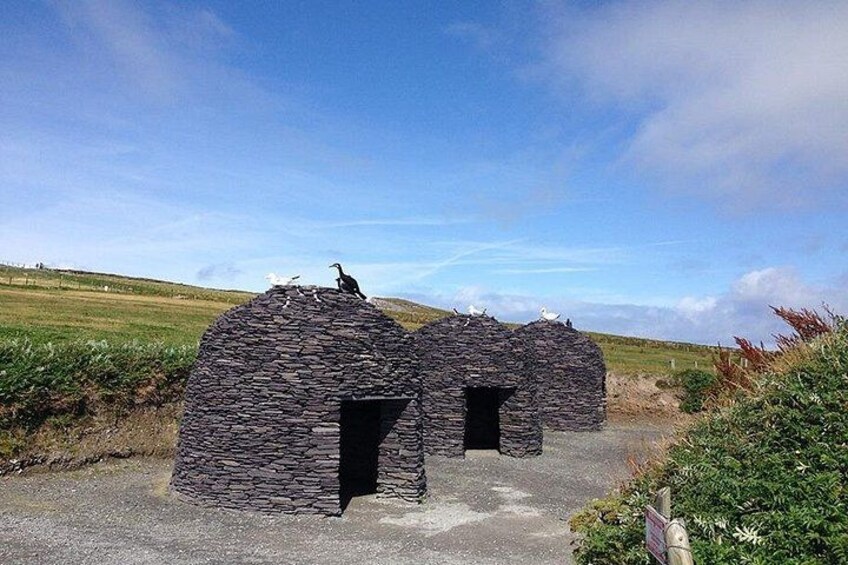 A stone structure with a bird perched on top. 2