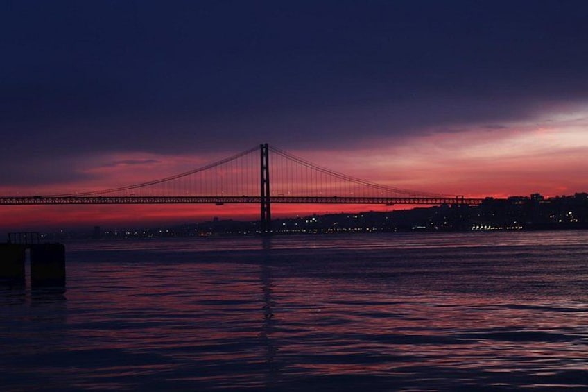 A bridge at sunset with water below. 4