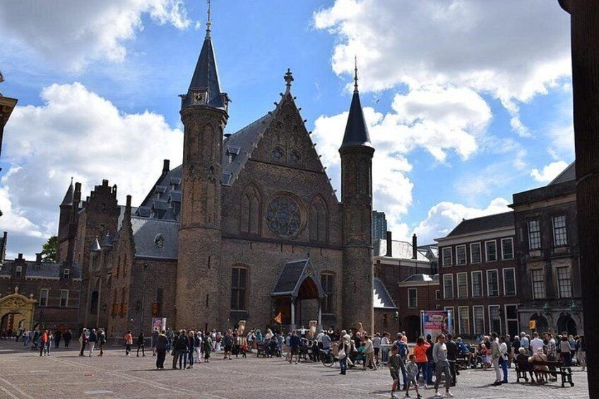 A historic church with two prominent towers and a large crowd in front. 5