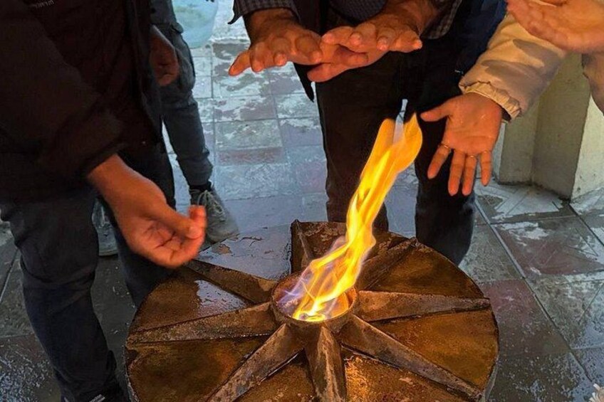 A fire burning in a metal structure with a circular base. 3