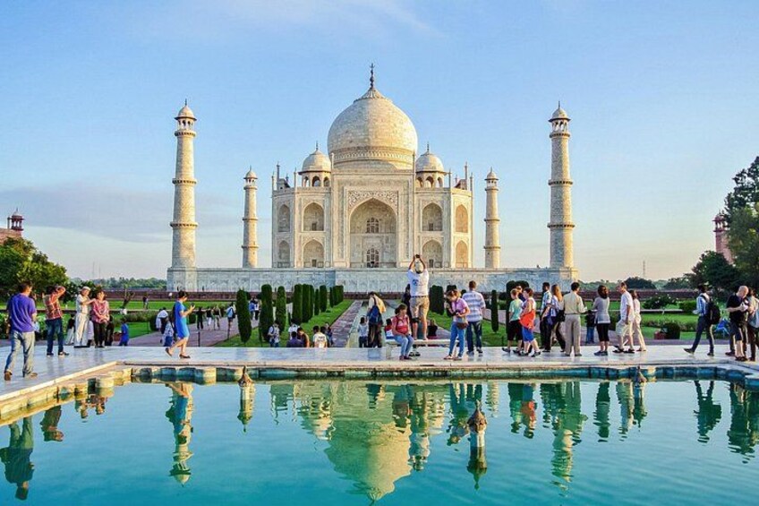 The Taj Mahal with visitors around its reflecting pool. 4