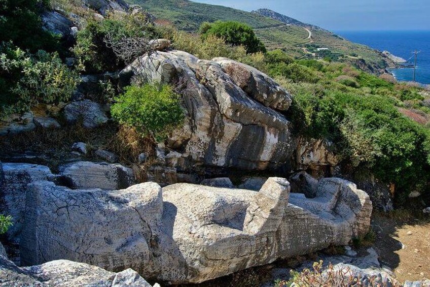 A rocky landscape with large boulders and sparse vegetation. 2