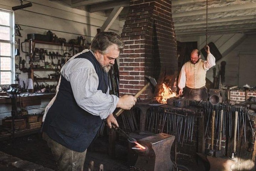 A blacksmith at work with a forge, anvil, and tools. 3