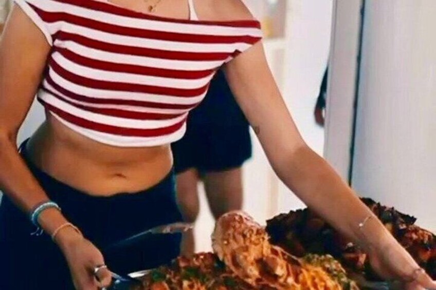 A person serving food at a buffet. 3