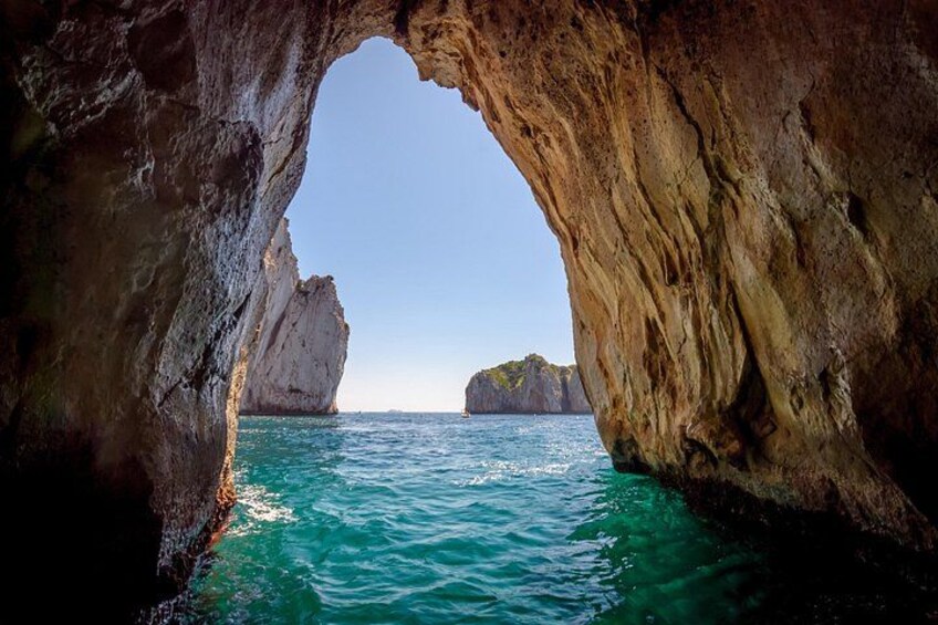 Boat through the iconic Faraglioni rock formations 1