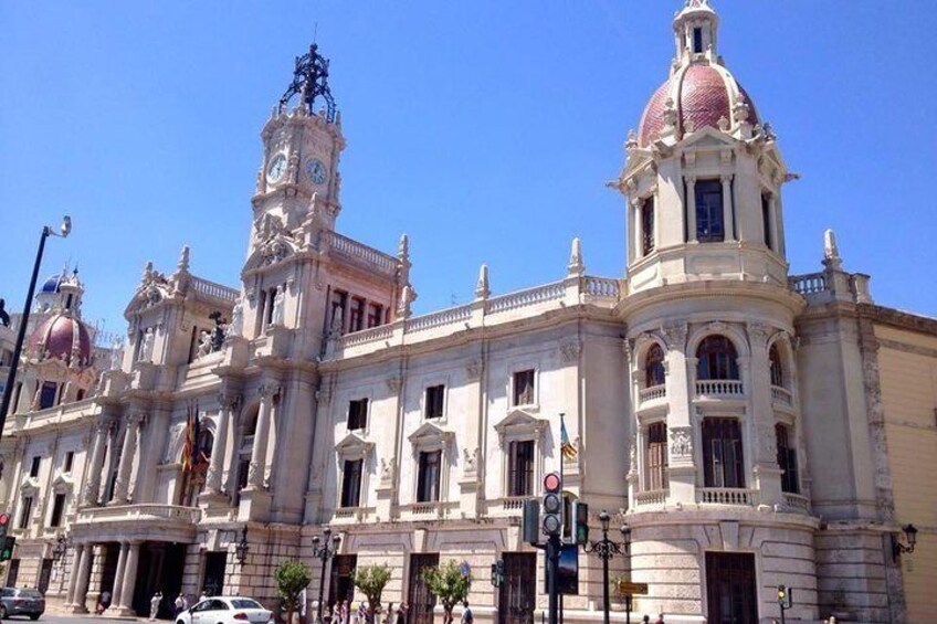 A historic building with ornate architecture, including domed towers and columns. 1