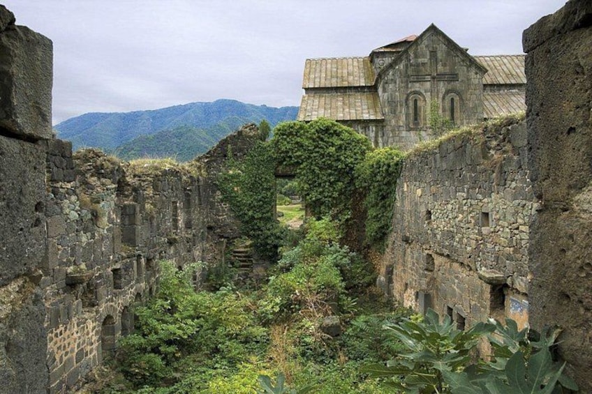 Ancient stone walls, a church, and a mountainous landscape. 2