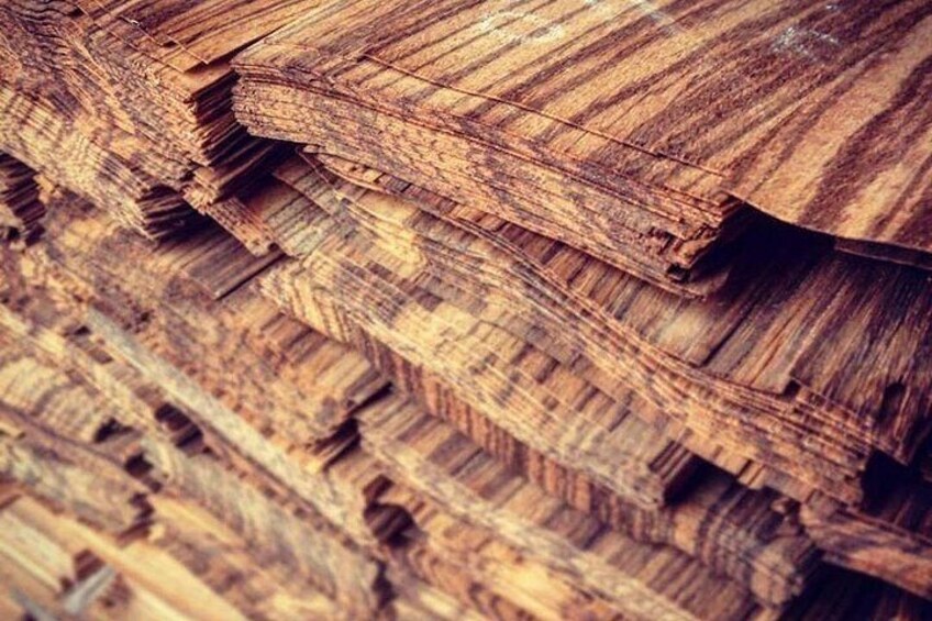 A close-up of stacked wooden planks with visible grain patterns and wood textures. 4