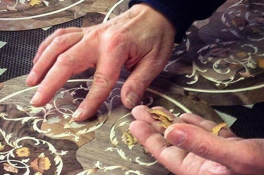 Hands handling a patterned fabric. 2