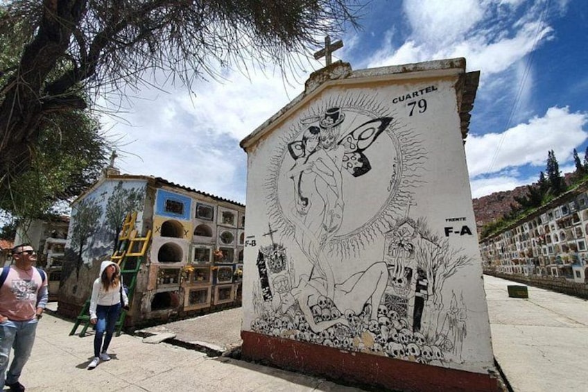 A mural with a cross, a figure, and the number 79 on a building. 1
