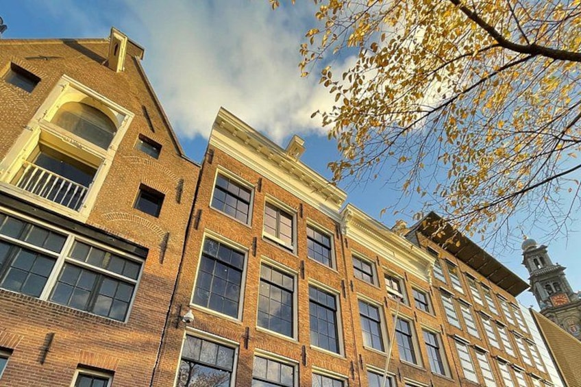 A row of brick buildings with multiple windows and a clear sky. 3