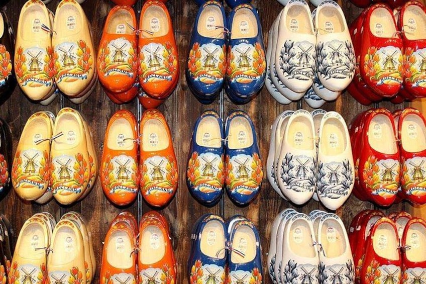 A collection of colorful wooden clogs with windmill designs. 5
