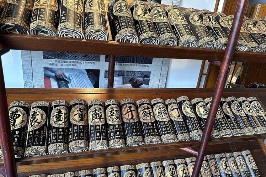 A collection of books with Chinese characters on their spines, arranged on wooden shelves. 5
