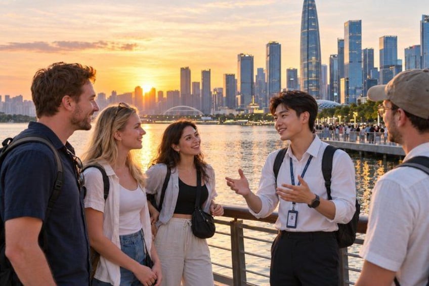 A group of people standing by a waterfront with a city skyline in the background. 1