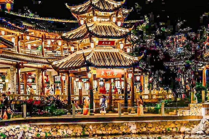 A traditional Chinese pagoda with ornate architecture, surrounded by a stone pathway and lush greenery. 3