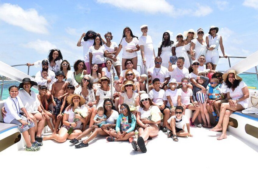 A group of people on a boat with a clear sky in the background. 3