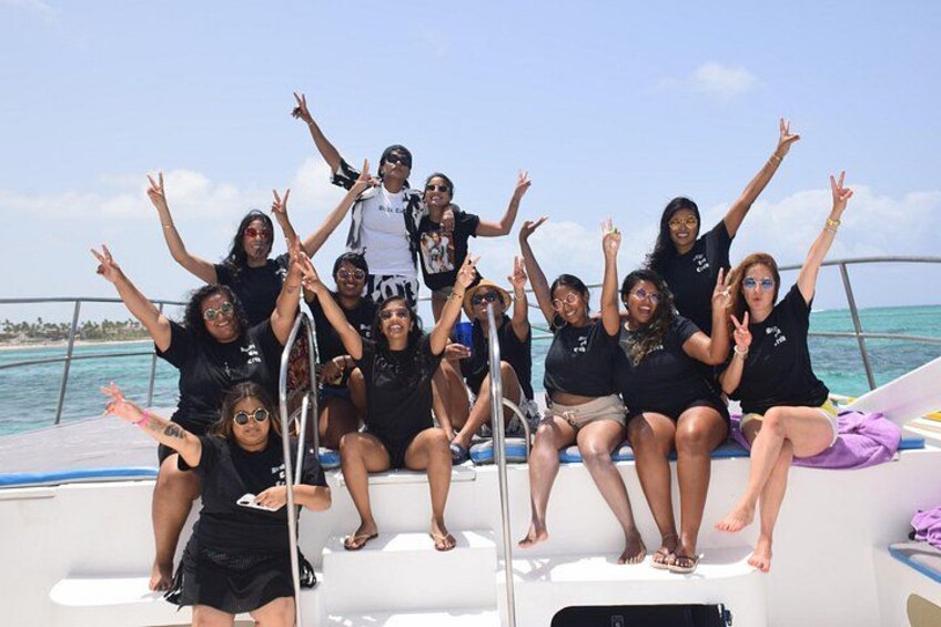 A group of people on a boat with the ocean and a clear sky in the background. 4
