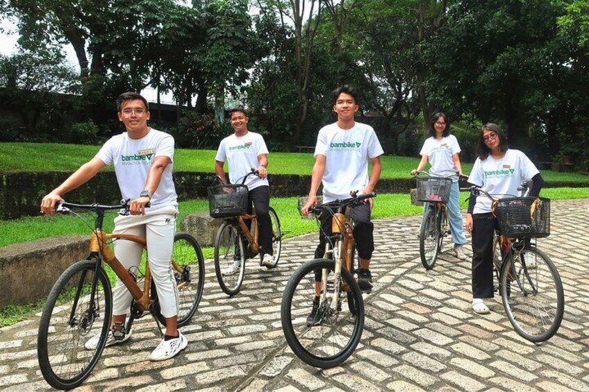 People riding bicycles on a paved path in a park. 3