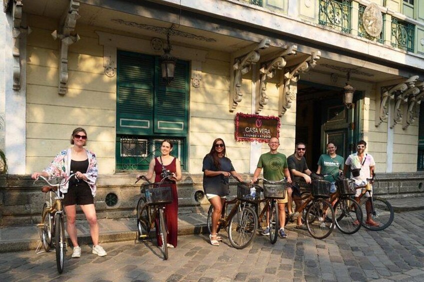 Un grupo de personas en bicicletas frente a un edificio con un letrero que dice 'CASA VERA'. 4