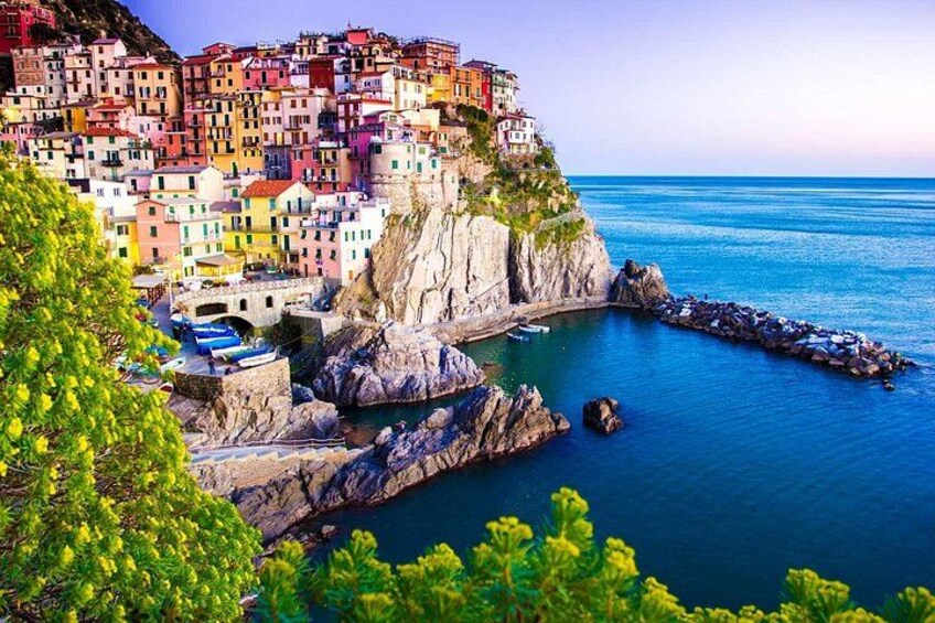A coastal town with colorful buildings perched on a cliff overlooking the sea. 2