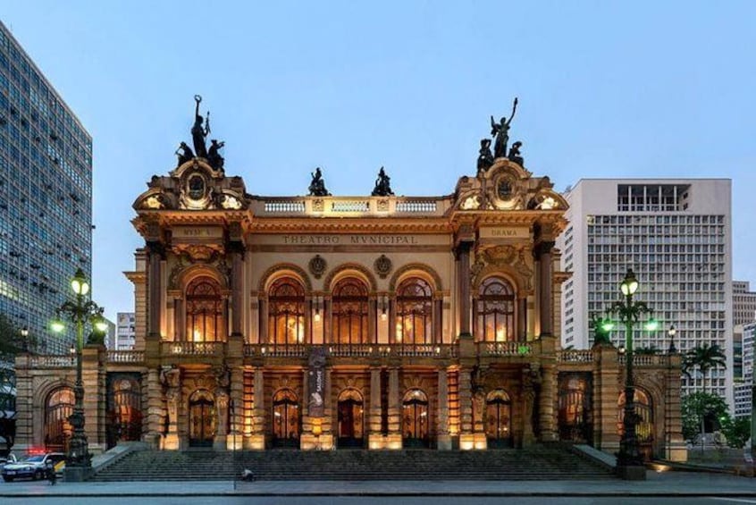 A grand, ornate building with multiple statues and arches, likely a theater or cultural institution. 2