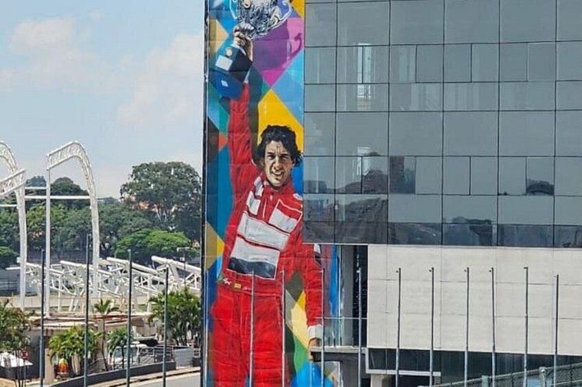 A mural of a person in a racing suit on a building. 1