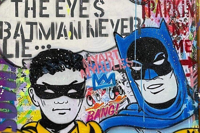 A graffiti wall with Batman and Robin characters, and text including 'THE EYE'S BATMAN NEVER LIES...'. 2