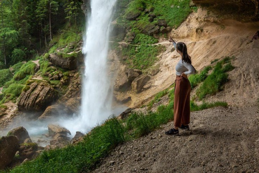 A girl is pointing Towards Pericnik Waterfall at Triglav National Park 3