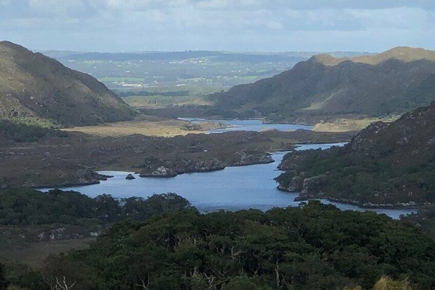 A valley with a lake surrounded by hills. 2