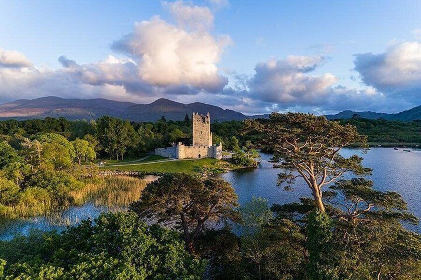 A castle surrounded by water and trees. 2