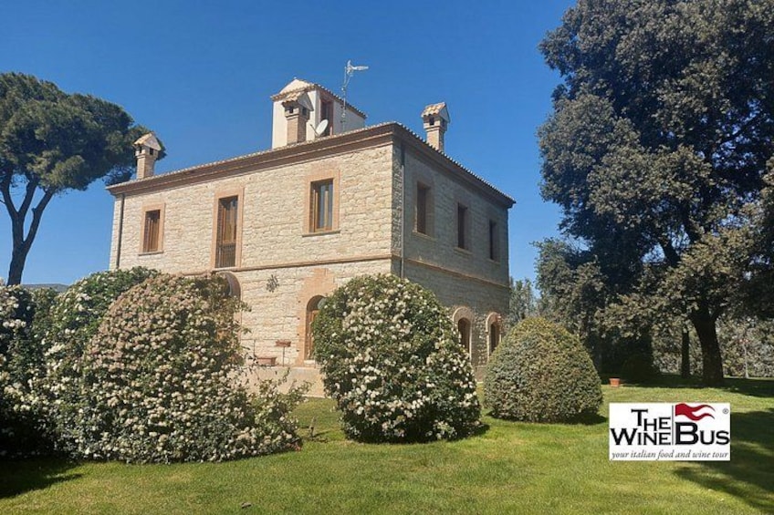 A stone building with a garden in front. 3