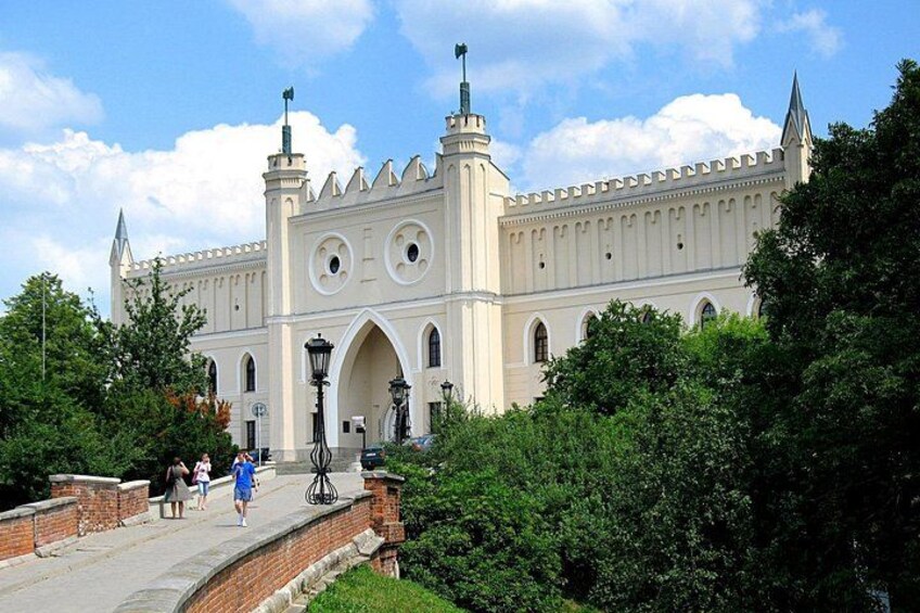 A large, historic building with arched windows and a tower. 2