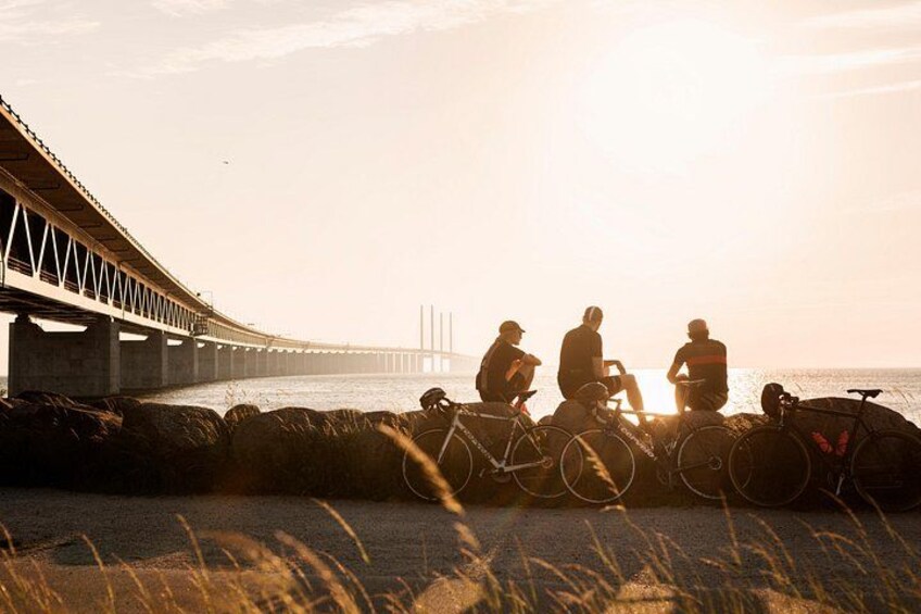 A bridge, cyclists, and a sunset. 2