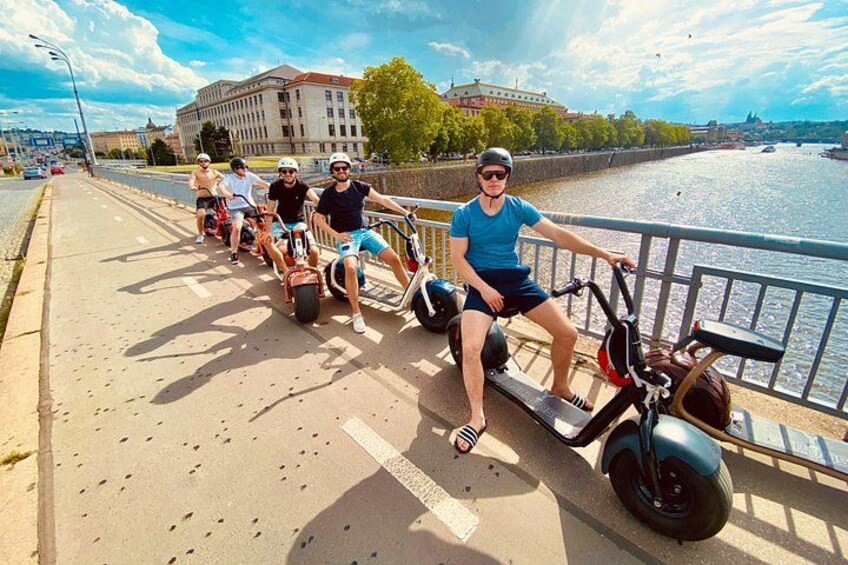 People riding electric scooters on a bridge. 2
