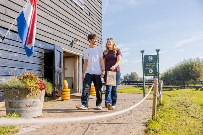 A wooden building with a flag, a signboard, and a pathway. 5
