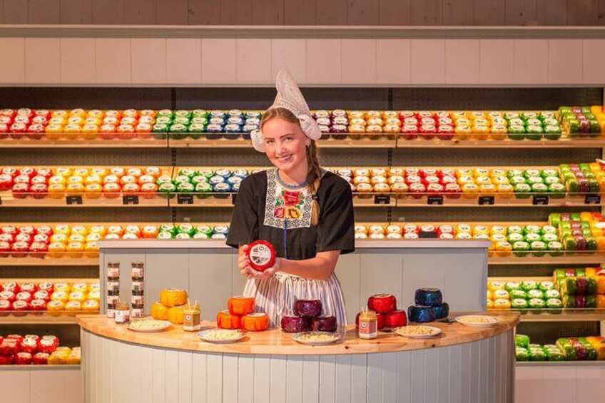 A person in a kitchen setting with shelves of colorful packaged goods in the background. 3
