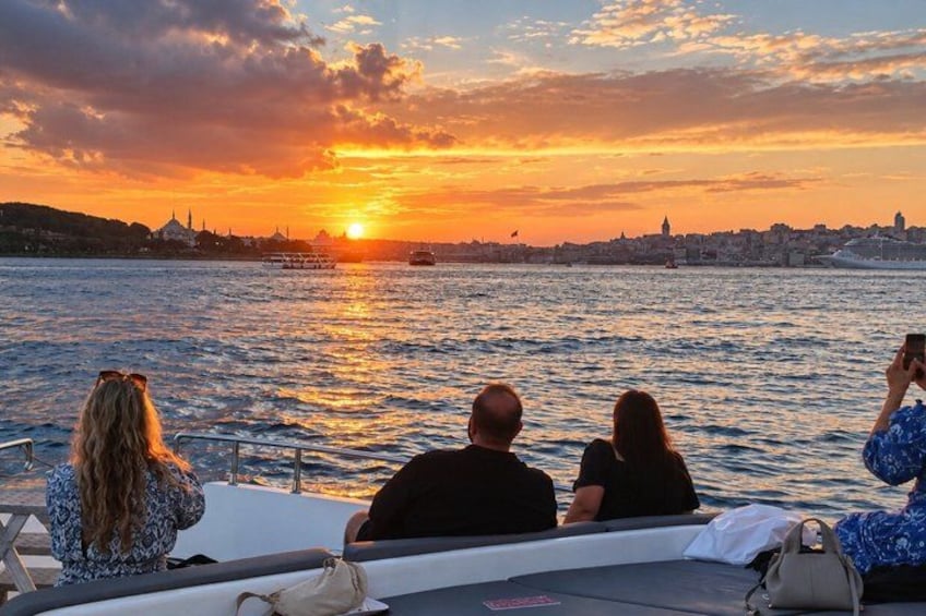 A sunset over a body of water with a city skyline in the background. 4