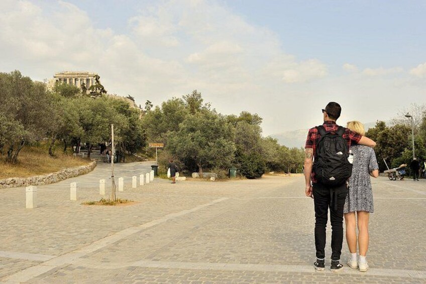 A paved pathway with trees and a distant view of an ancient temple. 3