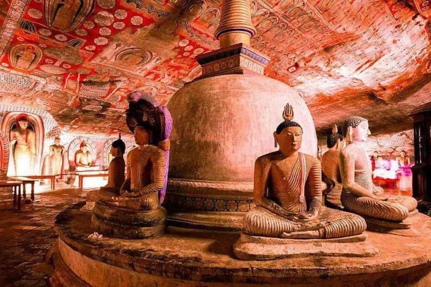 A temple interior with multiple Buddha statues and intricate ceiling artwork. 3