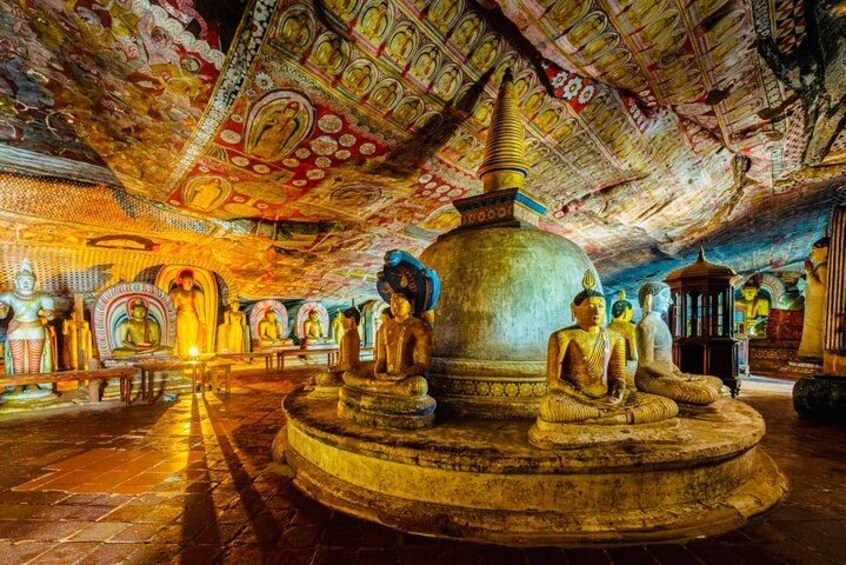 A temple interior with Buddha statues, intricate ceiling artwork, and a central stupa. 3