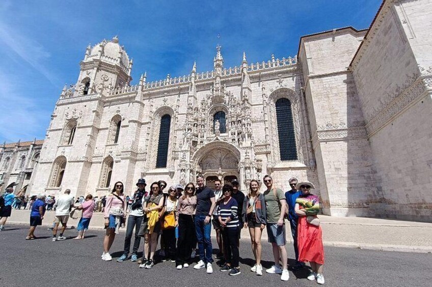 A group of people standing in front of a historic cathedral with intricate architecture. 5