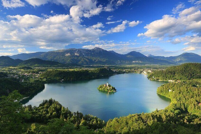 A lake surrounded by mountains and greenery. 1