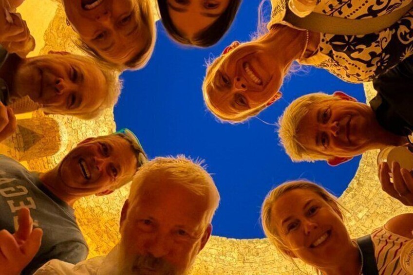 A group of people gathered in a circle, possibly for a photo. 1