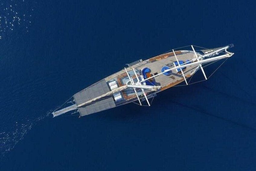 A large yacht with a streamlined hull and multiple decks, sailing on a deep blue ocean. 2