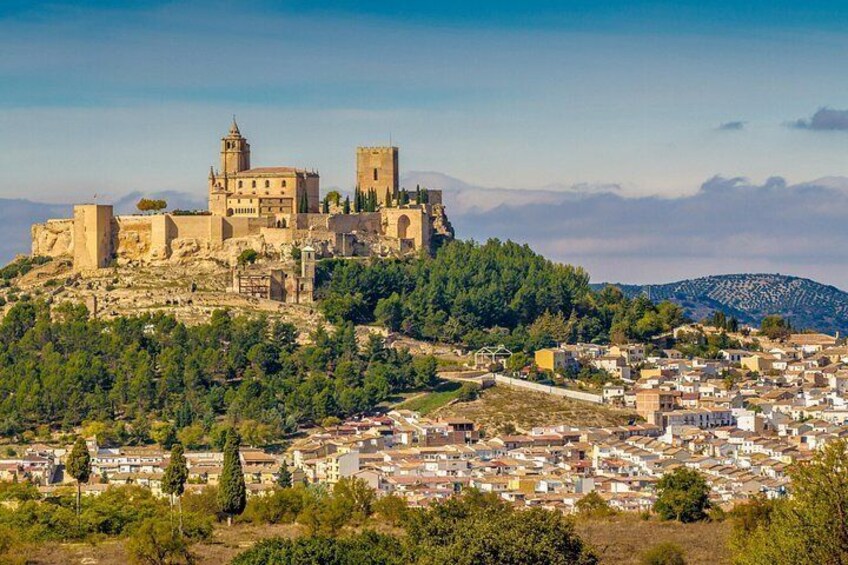 A historic fortified city with a prominent castle on a hill, surrounded by a dense residential area. 2